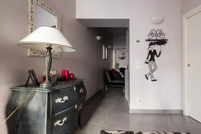 a living room with a lamp and a dresser at Residenza Romana Zucchelli in Rome