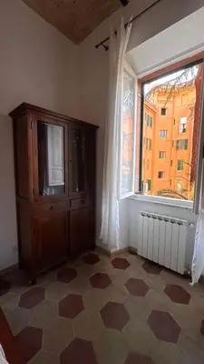 a room with a dresser and a large window at Casa Francesco in Rome