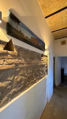 a stone wall with a train picture on the wall at Casa Francesco in Rome