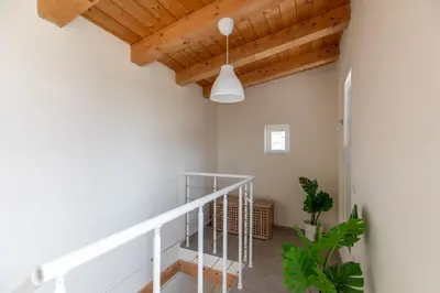 a staircase in a house with wooden ceilings at iFlat Scenic Penthouse with Terrace near Vatican in Rome