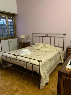 a bedroom with a large bed with a wooden floor at Vatican Lodge in Rome