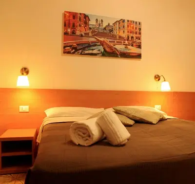 a hotel room with a bed with towels on it at Le tue Notti a San Pietro in Rome