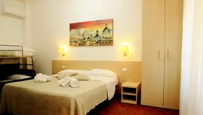 a hotel room with a bed with towels on it at Le tue Notti a San Pietro in Rome