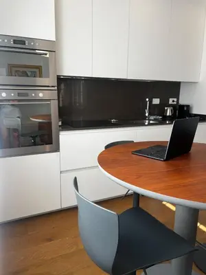 a kitchen with a table with a laptop on it at Casa Jacomini in Rome