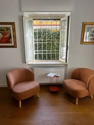 two chairs sitting in a room with a window at Casa Jacomini in Rome