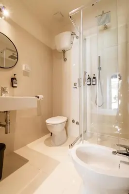 a bathroom with a shower and a toilet and a sink at Cunabu Calatafimi in Rome