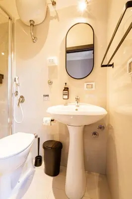 a bathroom with a sink and a mirror at Cunabu Calatafimi in Rome