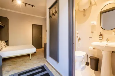 a bathroom with a toilet and a sink at Cunabu Calatafimi in Rome