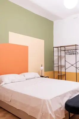 a bedroom with a large white bed in a room at Boutique apartment 10 min to Colosseum and Termini in Rome