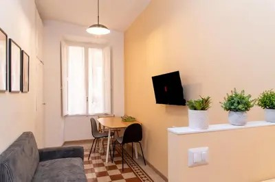 a living room with a couch and a table at Boutique apartment 10 min to Colosseum and Termini in Rome