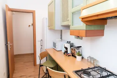 a small kitchen with a counter top and a stove at Boutique apartment 10 min to Colosseum and Termini in Rome
