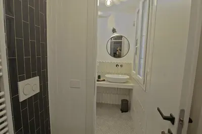 a bathroom with a sink and a mirror at Appartamento Pigneto in Rome