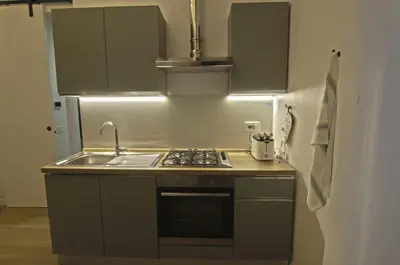 a kitchen with a sink and a stove top oven at Appartamento Pigneto in Rome
