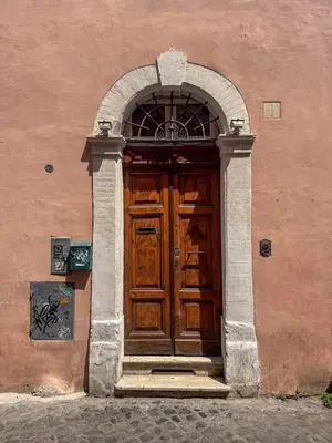 an entrance to a building with a wooden door at Trastevere Luxury Apartment in Rome