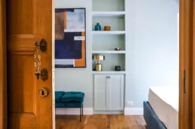 a door to a bedroom with a bed and a chair at Trastevere Luxury Apartment in Rome