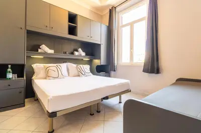 a hospital room with two beds and a window at Cunabu Castro Pretorio in Rome