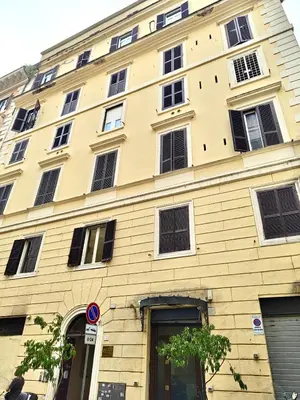 a large yellow building with many windows at Cunabu Castro Pretorio in Rome