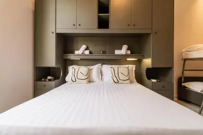 a bedroom with a large white bed with white pillows at Cunabu Castro Pretorio in Rome