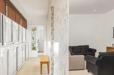 a living room with a couch and a table at ATRHOME- Penthouse Tritone in Rome