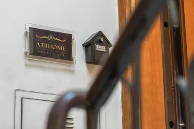 an entrance sign on a wall next to a door at ATRHOME- Penthouse Tritone in Rome