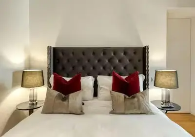 a bedroom with a large bed with red pillows at Vittoriano Pantheon apartment in Rome