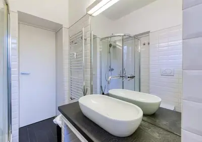 a white bathroom with a sink and a tub at Vittoriano Pantheon apartment in Rome