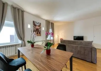 a living room with a table and a couch at Vittoriano Pantheon apartment in Rome