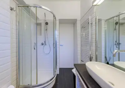 a bathroom with a shower and a tub and a sink at Vittoriano Pantheon apartment in Rome