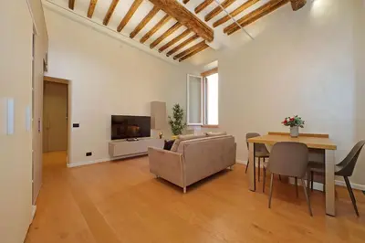 a living room with a couch and a table and a television at Loft al Pantheon by Luxury Getaways in Rome