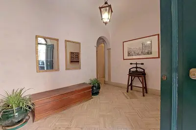 a hallway with a bench and two potted plants at Loft al Pantheon by Luxury Getaways in Rome