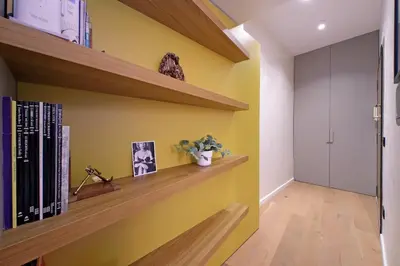 a room with yellow walls and wooden shelves at Loft al Pantheon by Luxury Getaways in Rome