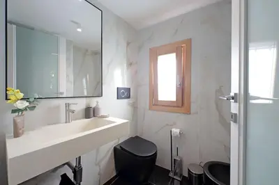 a bathroom with a sink and a toilet and a mirror at Loft al Pantheon by Luxury Getaways in Rome