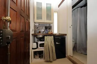 a kitchen with a wooden door next to a sink at Quiet nest in Campo De' Fiori in Rome