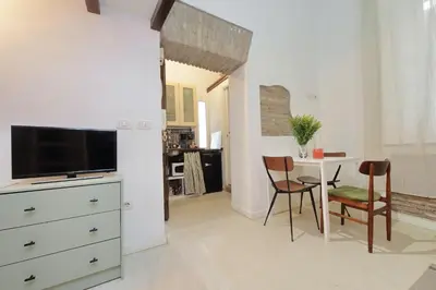 a living room with a blue couch and a mirror at Quiet nest in Campo De' Fiori in Rome