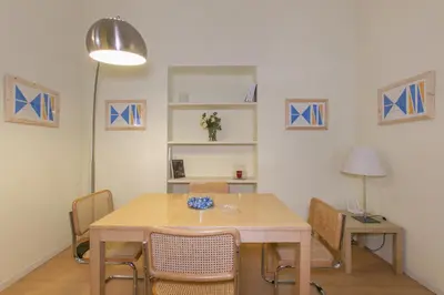 a living room with a table and a dining room at Rome Central Suite via Porcari in Rome