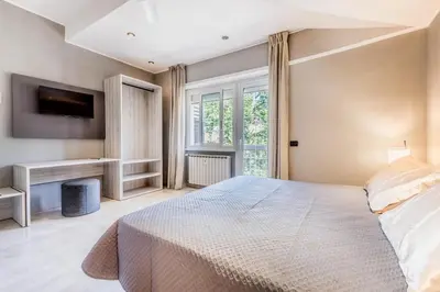 a bedroom with a large bed and a desk at Guest House Ionio in Rome