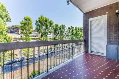 a balcony with a fence and a door at Guest House Ionio in Rome