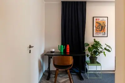 a black desk with a chair in a room at GuestHost - Colorful Apt in Vintage-Modern Style in Rome