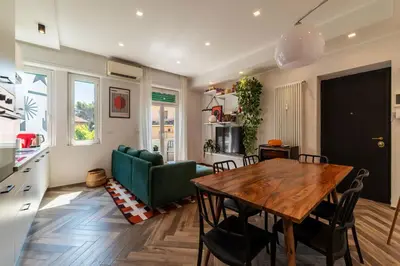 a living room with a table and a green couch at GuestHost - Colorful Apt in Vintage-Modern Style in Rome