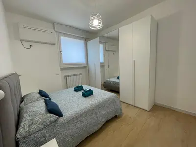 a bedroom with a bed with blue pillows on it at Family Domus Via Latina in Rome