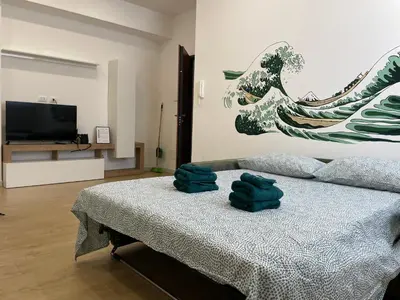 a bedroom with a bed with two green towels on it at Family Domus Via Latina in Rome
