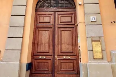 a large wooden door in a building at Roma city center stay San Giovanni in Rome