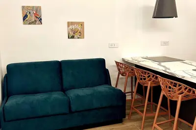 a living room with a green couch and a table at Roma city center stay San Giovanni in Rome