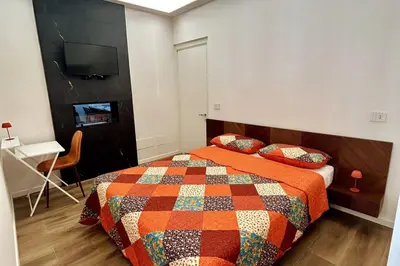 a bedroom with a bed with a colorful quilt at Roma city center stay San Giovanni in Rome