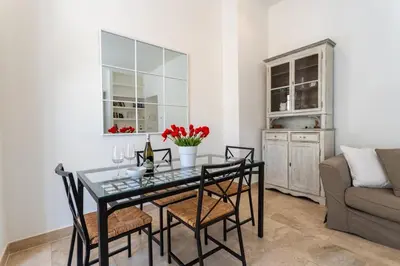 a dining room with a table and chairs and a couch at Pgrhome Civinini in Rome
