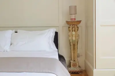 a bedroom with a bed with a candle next to it at YCH-Elegante appartamento vicino Villa Ada in Rome