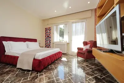 a bedroom with a bed and a flat screen tv at YCH-Elegante appartamento vicino Villa Ada in Rome