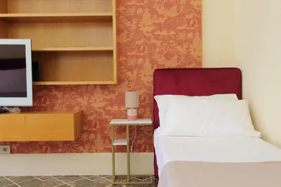 a bedroom with a bed and a tv and a desk at YCH-Elegante appartamento vicino Villa Ada in Rome