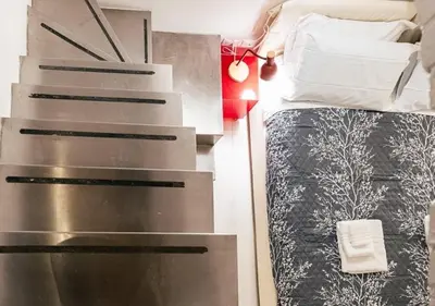 a small bedroom with a bed and a desk at Roma Suite Piazza Navona in Rome