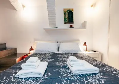 a bedroom with a bed with white towels on it at Roma Suite Piazza Navona in Rome